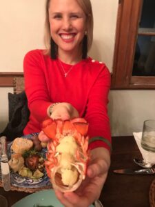 Creative dinner, woman holding cauliflower in lobster tail 