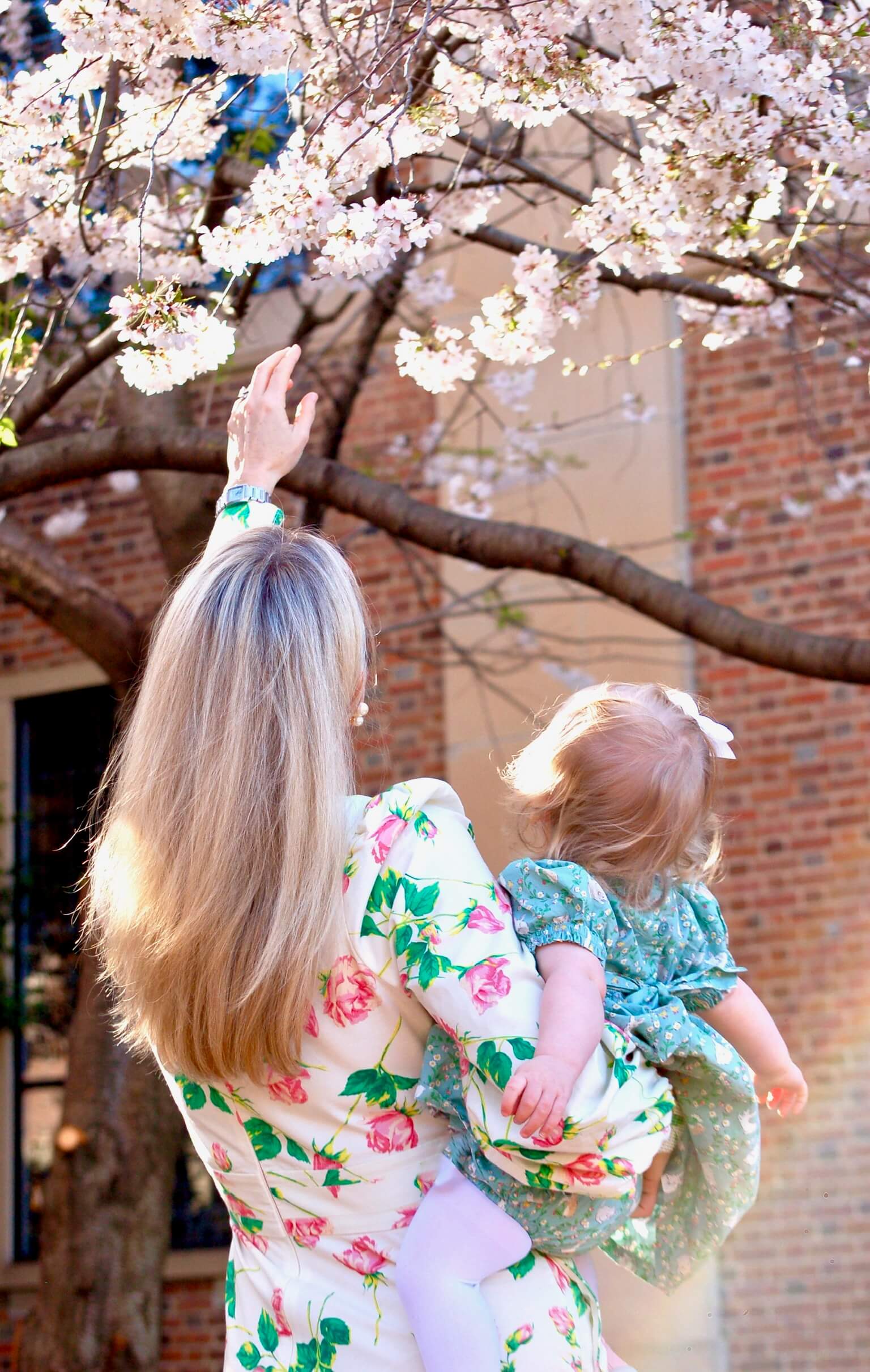Mother and Daughter in front of a cherry blossom tree